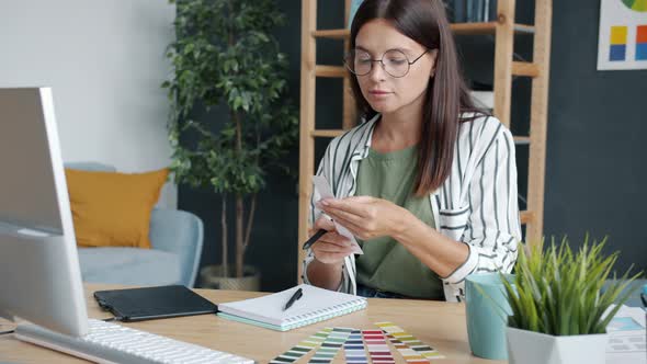 Portrait of Young Woman Developing Smartphone App Using Computer and Graphics Tablet Working at Home alt