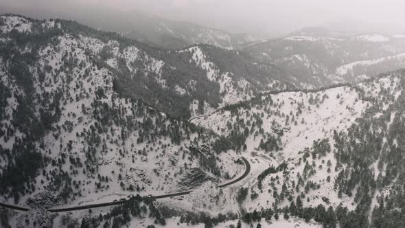 4k view of the forest, clouds and trees above the Rocky Mountains outside Boulder, CO on snowy day alt