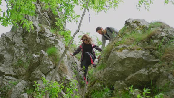 Hikers descending a mountain alt