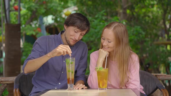 In a Cafe Young Couple Have a Chat alt