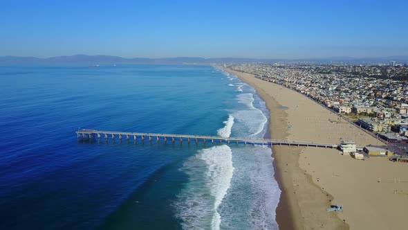 Aerial drone uav view of a pier over the beach and ocean alt