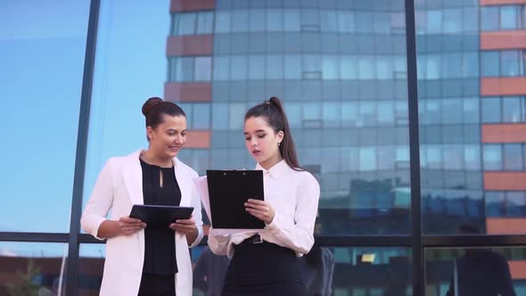 The Businessman Tells Good News to Two Business Girls and They are Happy alt
