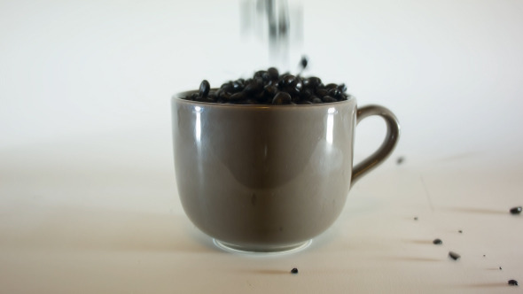 Pouring Coffe Beans In Big Coffee Mug 02