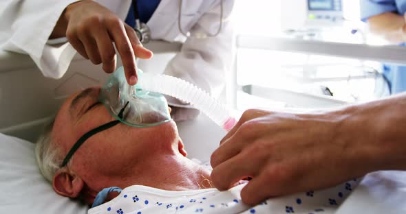 Doctor putting oxygen mask on a female senior patient face, Stock Footage