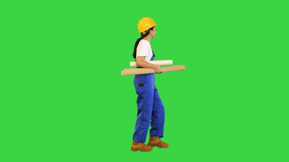 Woman Holding Wallpaper Rolls Walking on a Green Screen Chroma Key alt
