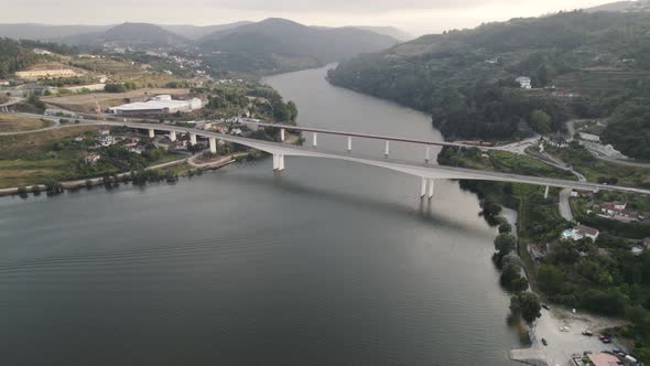 Bridges over meandering Douro River against mountains, Entre-os-Rios, Portugal. Aerial view