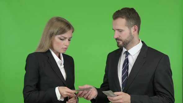 Male and Female Business Professionals Arguing About Money Against Chroma Key alt