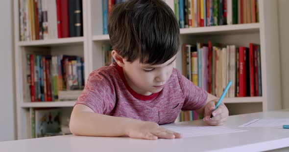 Left Handed School Child Writing With Pen alt