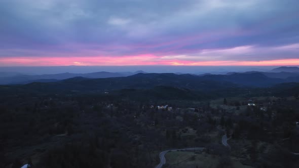 Hyper Lapse Drone Aerial View of Cinematic Pink Sunset Under Scenic Blue Clouds alt