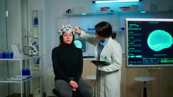 Doctor Analysing Brain Scan Using Tablet Examining Evolution of Disease alt