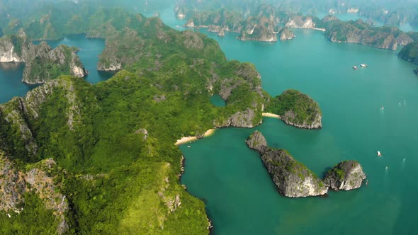 Aerial: flying over Ha Long Bay rock pinnacles, famous tourism destination in Vietnam alt
