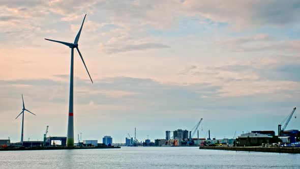 Wind Turbines in Antwerp Port on Sunset. alt