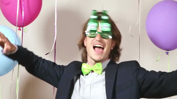 Funny man dancing wearing beer sunglasses in photo booth alt