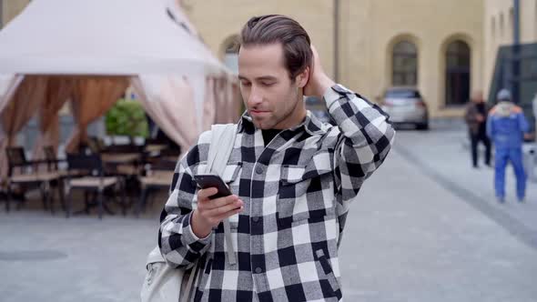 Guy standing at the street.