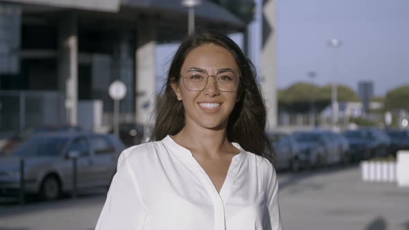 Attractive Young Dark-haired Girl Smiling Into Camera alt