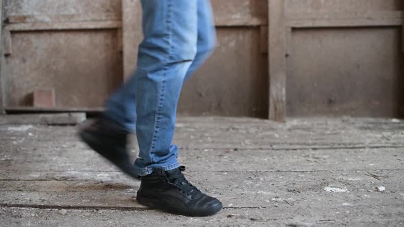 teenager walks along a decrepit floor, rotten boards bend under his boots alt