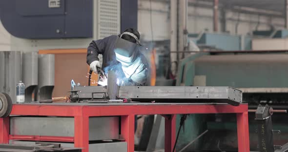Factory worker welding metal