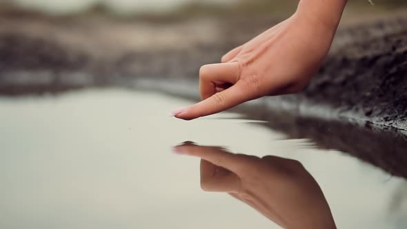 Hands Playing And Touching Water In Slow Motion. Woman Having Fun On Holiday Vacation Weekend Trip. alt