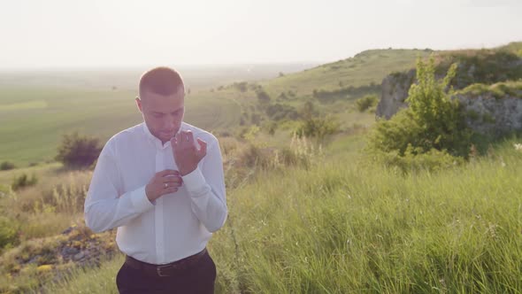 Slow Motion of Young Groom That Pinch His Button alt