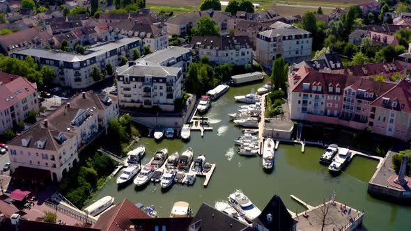 Aerial view of a small town surrounded by a river.  alt