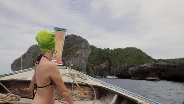 Happy Woman Traveler in Bikini Relaxing on Boat