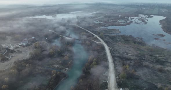 Aerial View of Mountain Road and a Cinematic Foggy Scenario River and Road alt
