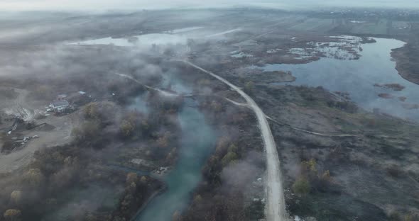 Aerial View of Mountain Road and a Cinematic Foggy Scenario River and Road