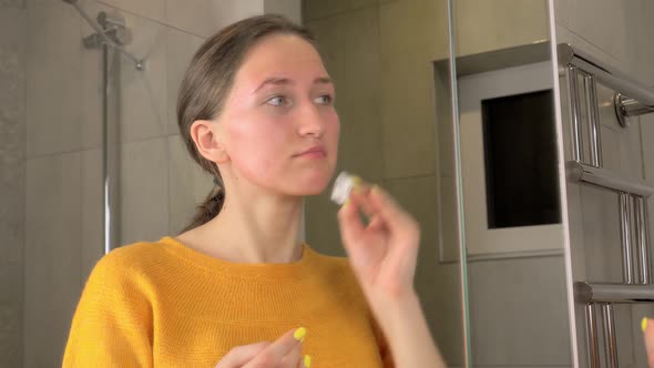 Young woman washes off removes makeup before bedtime skin care routine alt