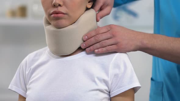 Therapist Applying Female Patient Foam Cervical Collar, Medical Support alt