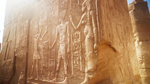 Close up of intricate carvings in the stone of a pillar in Karnak Temple, Luxor Egypt. Slow rotatio alt