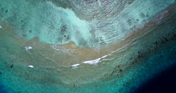 Wide angle above island view of a summer white paradise sand beach and aqua blue water background in alt
