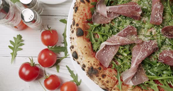 Delicious Pizza with Prosciutto Parma Ham Arugula Salad Rocket with Ingredients alt