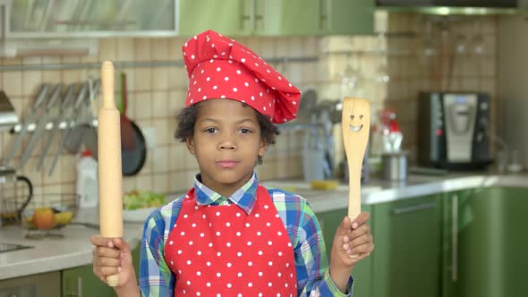 Cheerful Boy with Kitchen Utensils. alt