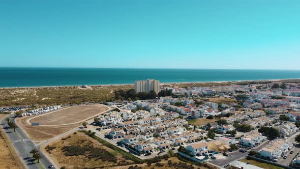 Relaxed Hotel With View Of Altura Beach In Altura, Portugal On A Sunny Summer Day. aerial alt