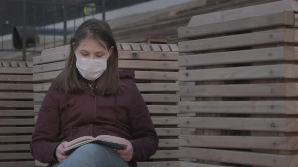 Young Girl in Black Mask Alone Outdoors. Coronavirus Pandemic