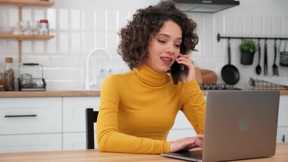 Smiling Hispanic Curly Woman Student Talking on Mobile Phone Using Laptop alt