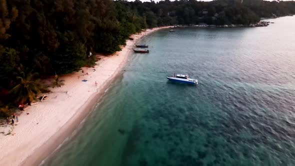 Aerial Flying Over Along Koh Lipe With Moored Longtail Boats During Sunset. Dolly Forward alt