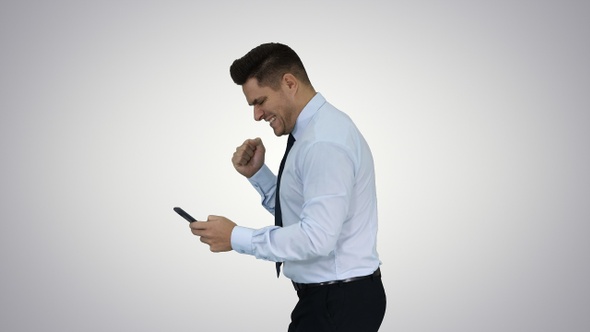 Happy business man walking in frame using mobile phone alt