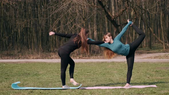 Sport Women Are Doing Morning Yoga Exercise Outside on Mats alt