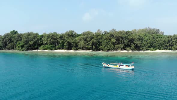 Aerial view of a beautiful island in the ocean with a boat