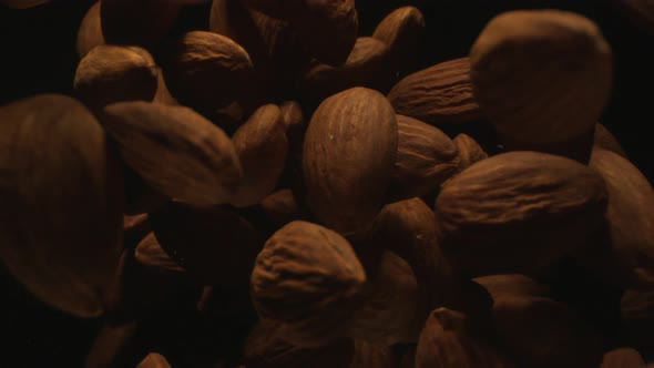 Almonds Nut Falling In High Speed On The Black Background A Macro Shot alt
