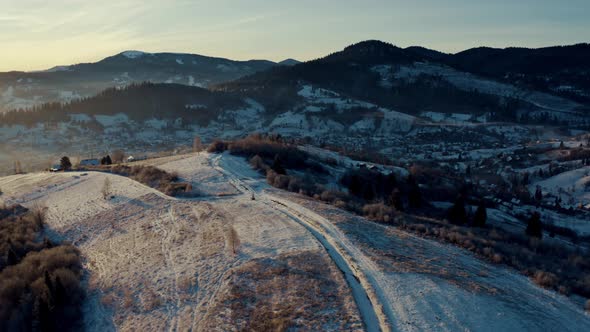Aerial View of the Village in Winter Mountains Sunrise in Winter Carpathian Mountains Aerial View alt
