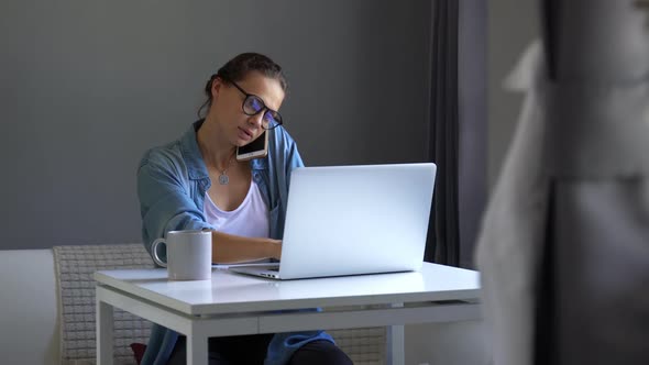 Young Woman Busy Working at Home Using Her Laptop alt