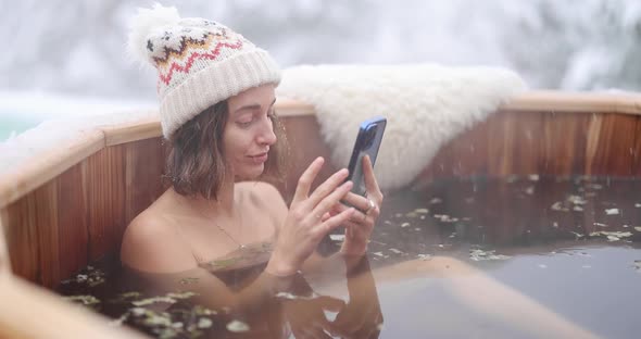Woman Relaxing in Hot Bath at Snowy Mountains alt