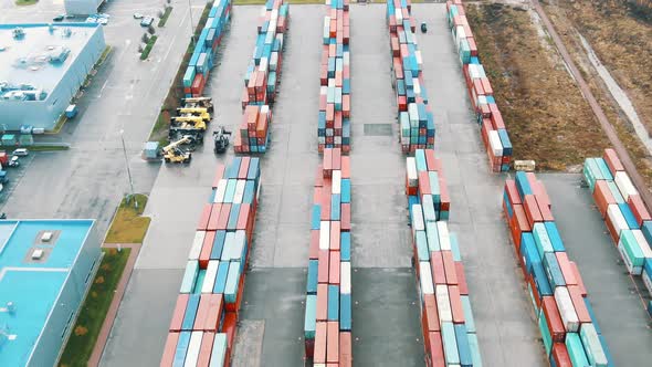 Cargo Container Stacks on Open Ground By Warehouse Upper alt