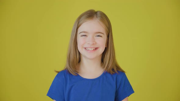 Happy and Beautiful Girl Looking at the Camera and Smiling alt