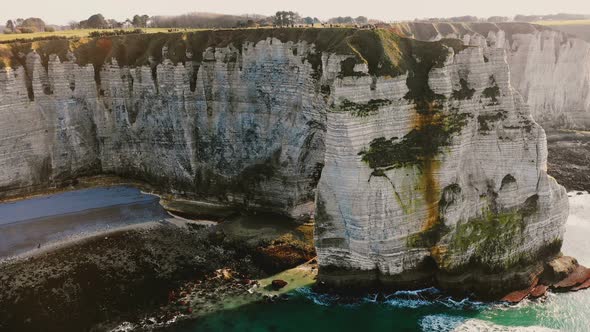 Majestic Aerial Medium Shot View of Epic Famous White Chalk Cliff Seaside Bay Near Sunny Sunset alt
