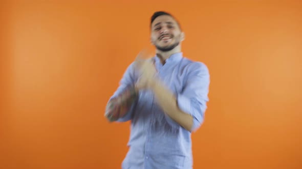 Expressive Energetic Young Man Dancing Fast with Hands Listening Music Against Background. Winning alt