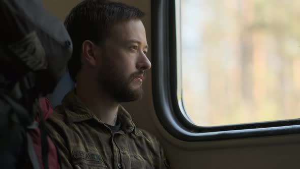 A man looking through the train window	