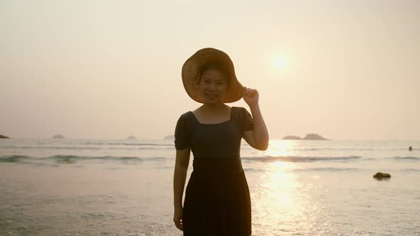 asian female traveller casual cloth with hat walking enjoy serence sunset